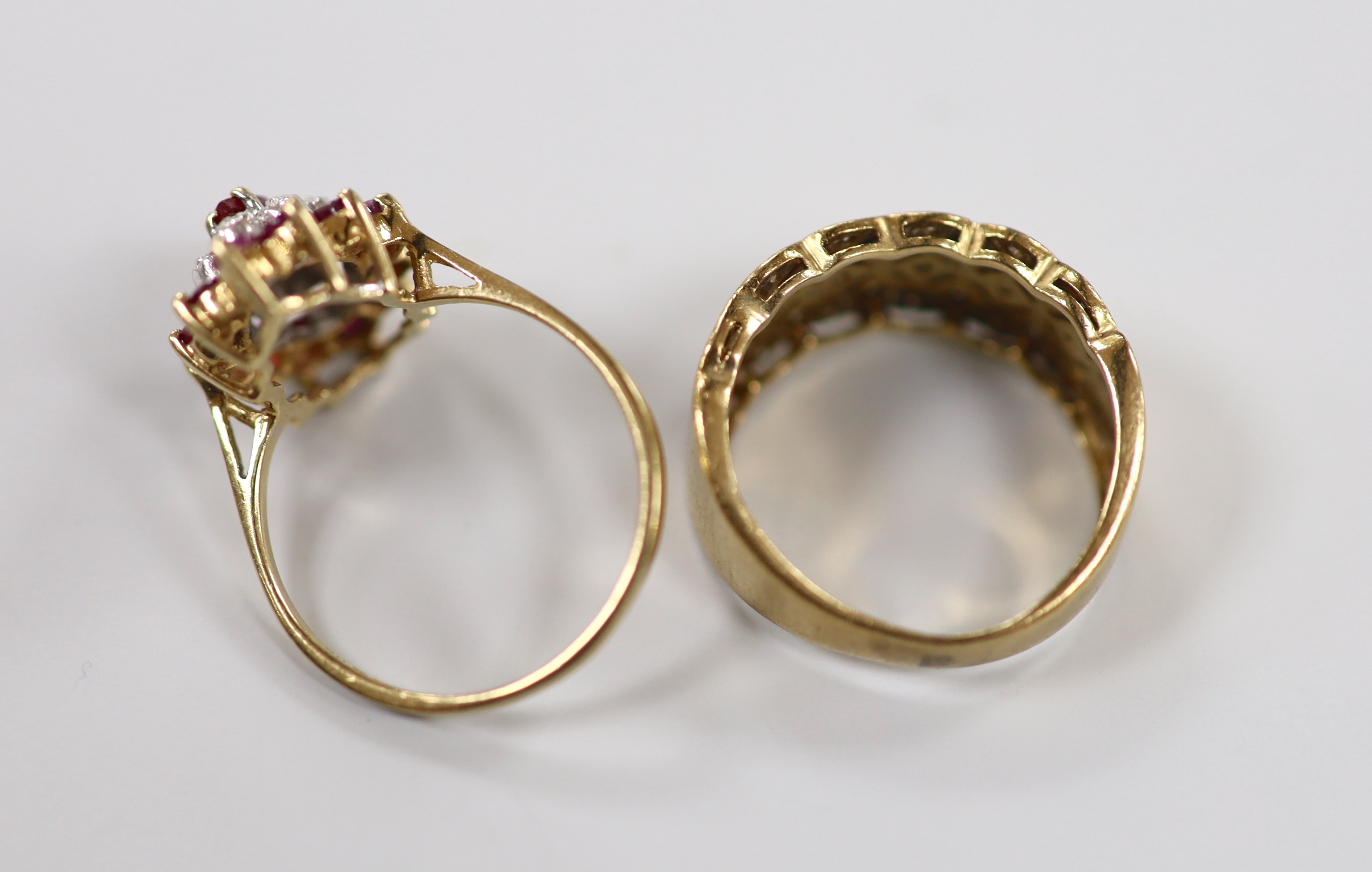 A modern 9ct gold, ruby an diamond chip set marquise cluster dress ring, size M and a similar 9ct gold and diamond chip ring, gross weight 5.5 grams.